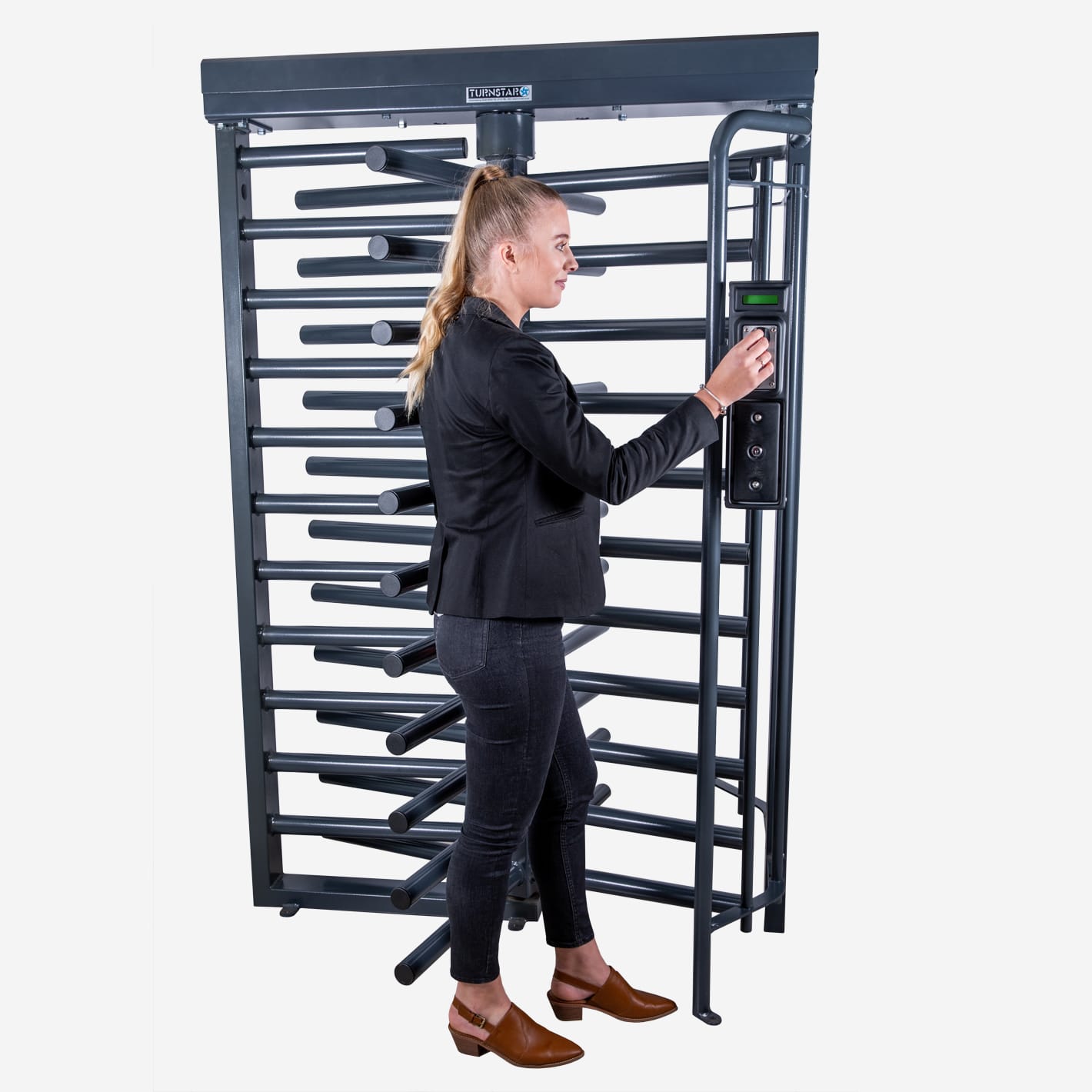 Woman inserting a coin into a coin acceptor on a full-height turnstile.