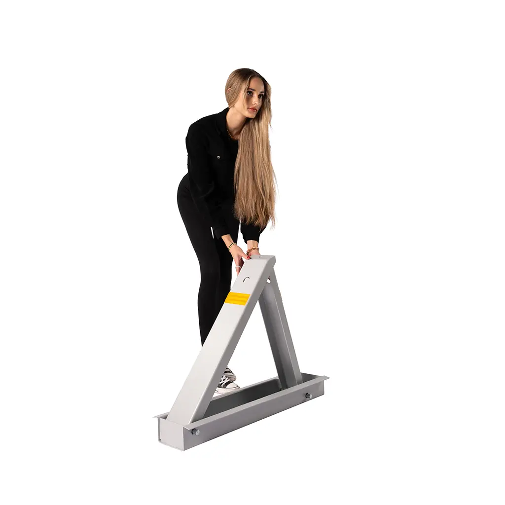 Woman lifting a MyCar blocker into its raised position by hand.