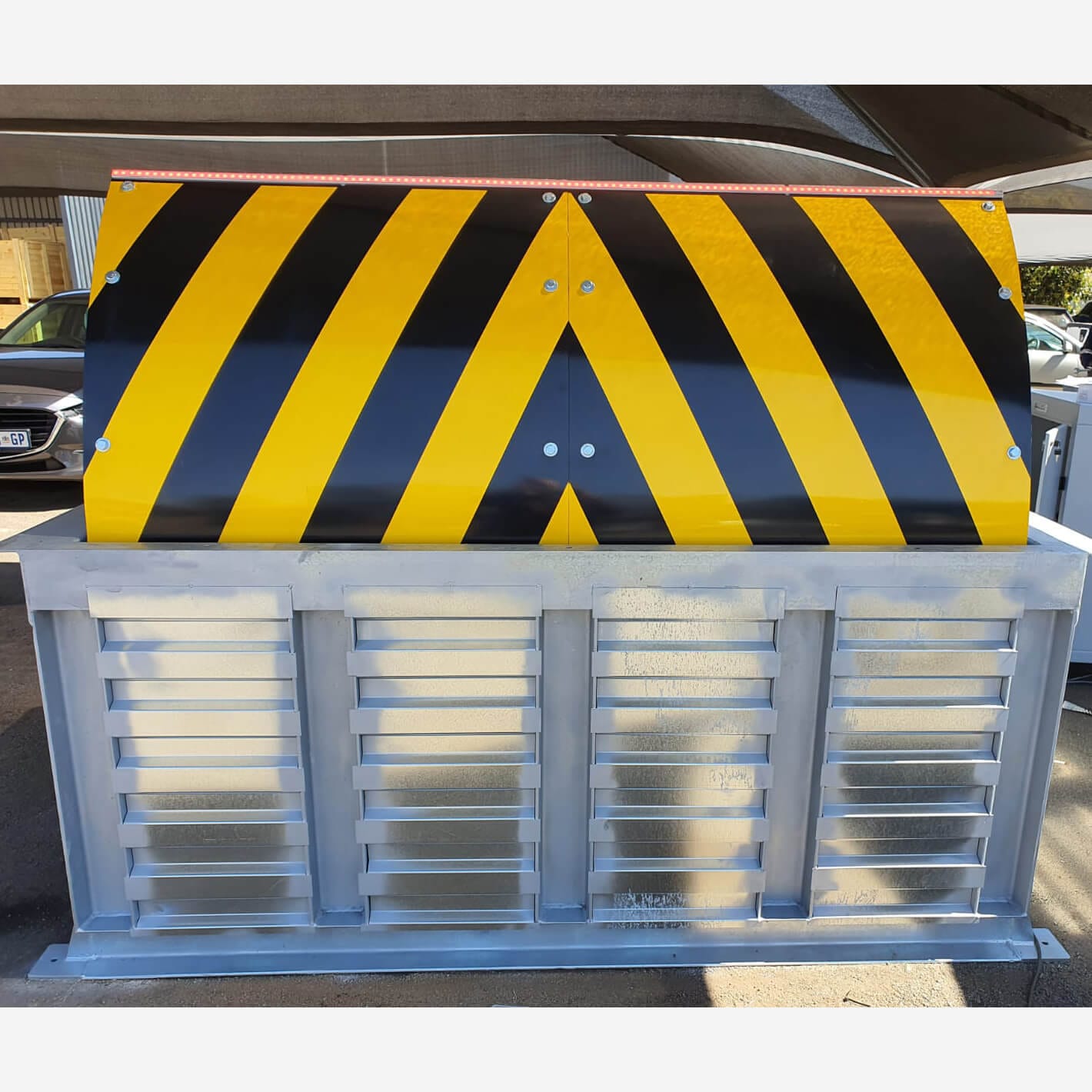 Galvanised Shield road blocker with a chevron wedge, ready for installation.