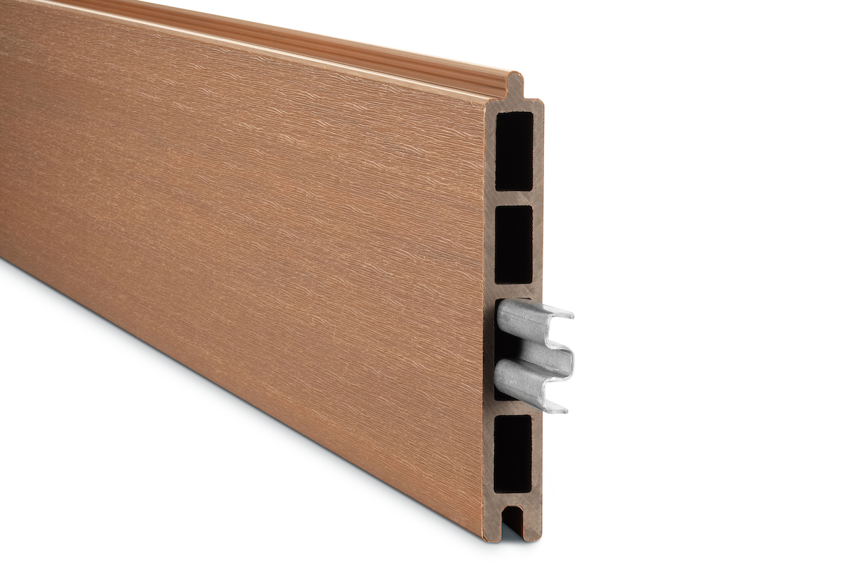 Gardenode Equinox co-extruded composite fence slat in teak, product shown alone, with steel reinforcement profile.