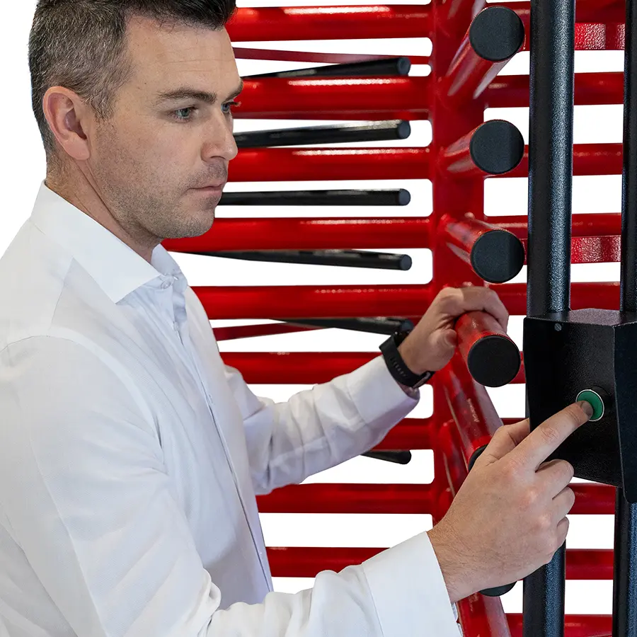 Man pressing the start button on the reader box inside a Tribune turnstile.