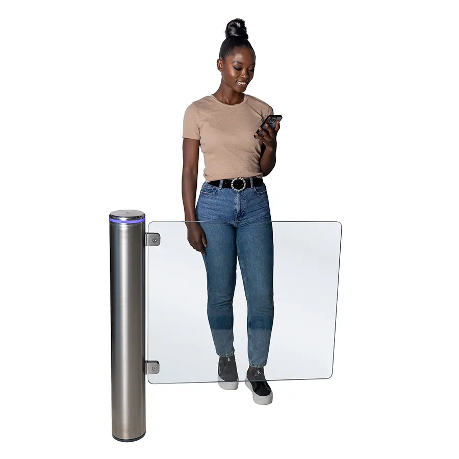 A woman with a phone walks through a stainless steel Pulse gate as the glass wing opens.