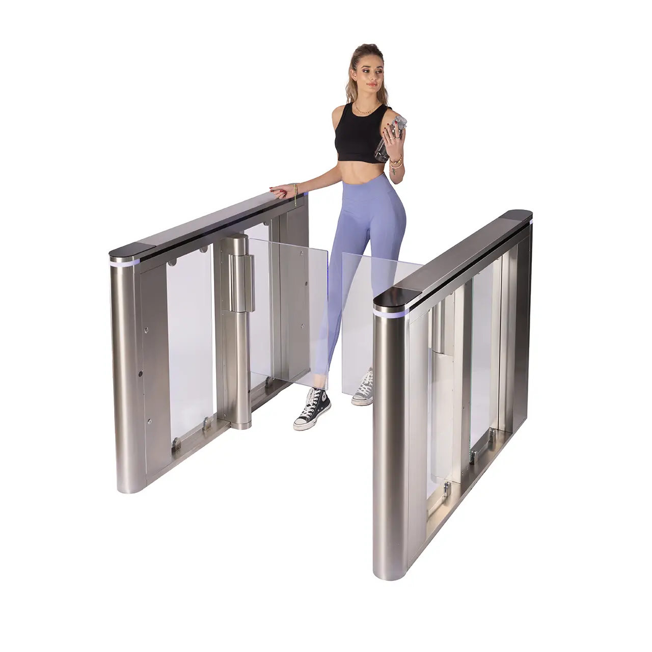 A woman passes through a stainless steel Speedgate Kinetic lane as the wings open.