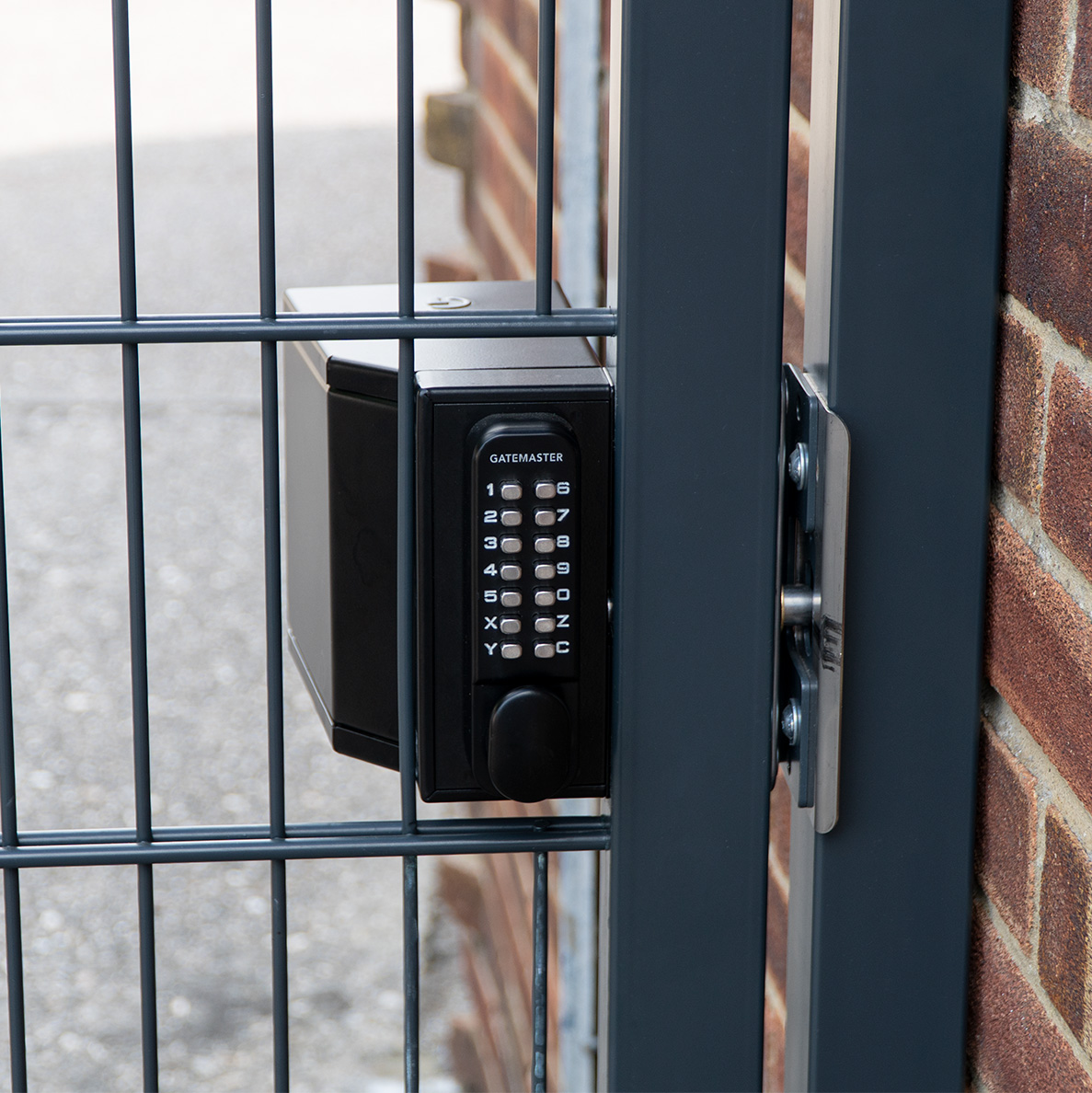 Gatemaster Superlock Quick Exit Security Shroud, fitted to a dark gate over a keypad lock