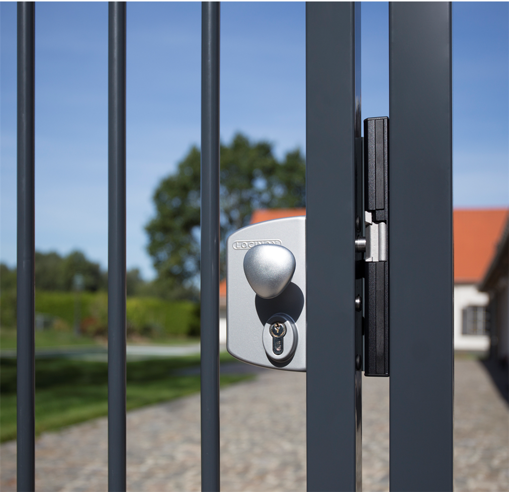 Silver Locinox gate lock with round knob on a bar gate