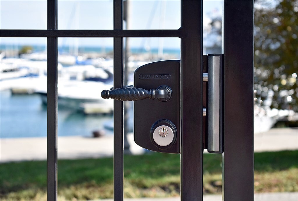 Black Locinox mortise cylinder gate lock on a bar gate by a marina