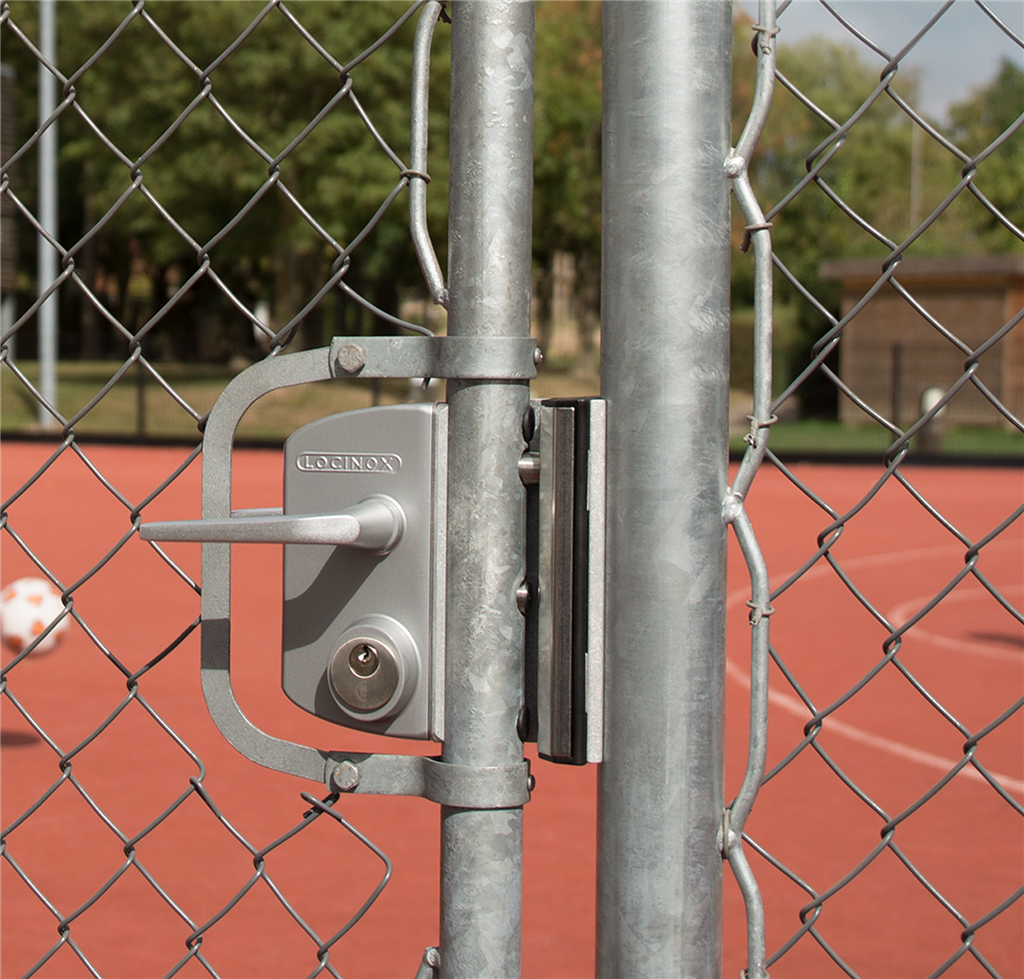 Silver Locinox mortise cylinder gate lock on a chain link gate