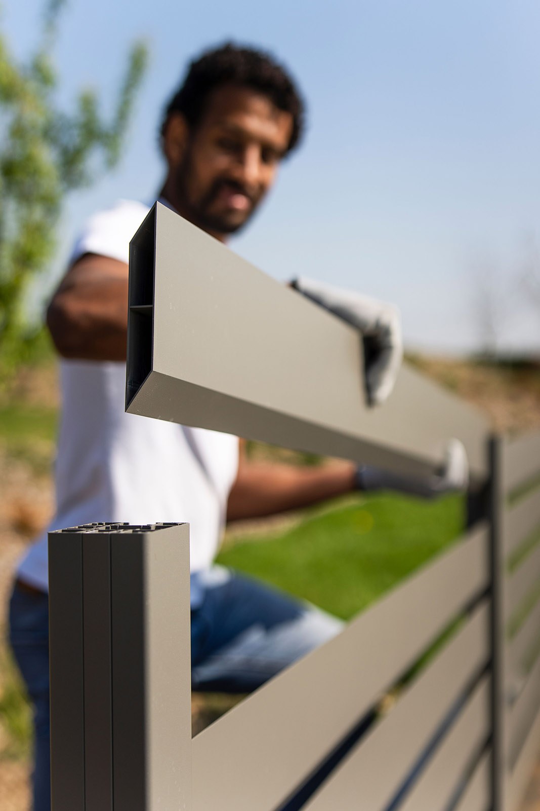 Gardenode Equinox aluminium slat being slid into a post