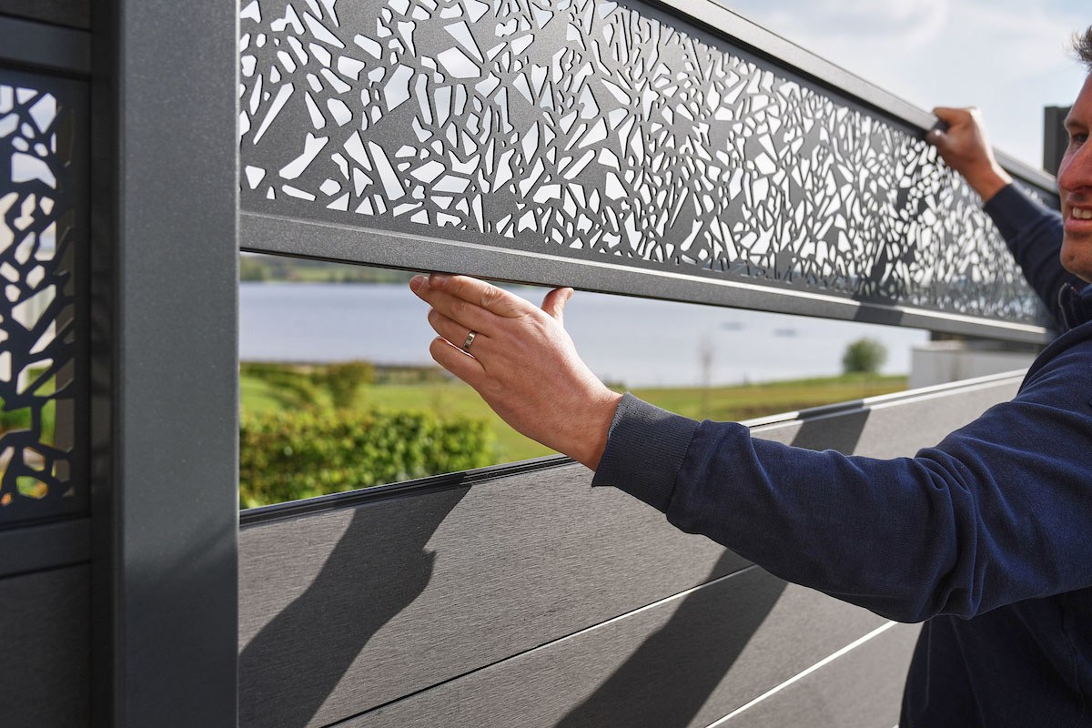 Gardenode Equinox laser-cut decorative panel being fitted into a framing kit