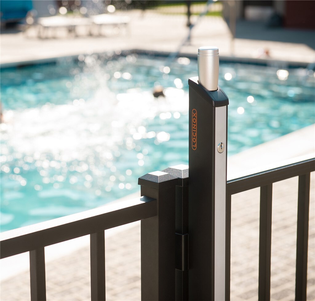 Fortima latch on a square post of a black gate at a pool