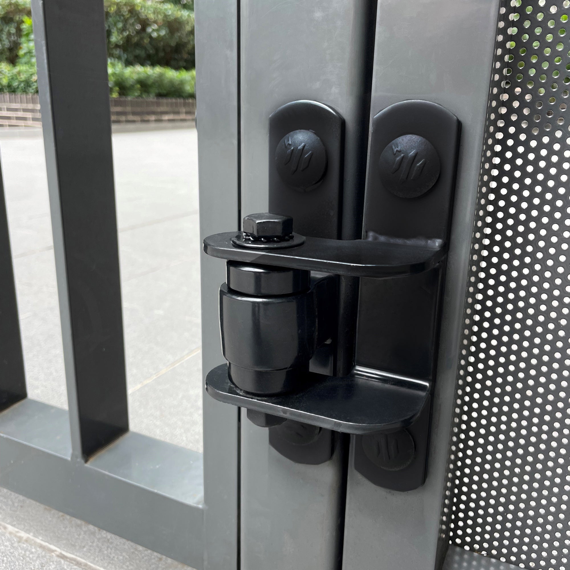Black Shut It face mount bolt-on hinge fitted to a gate