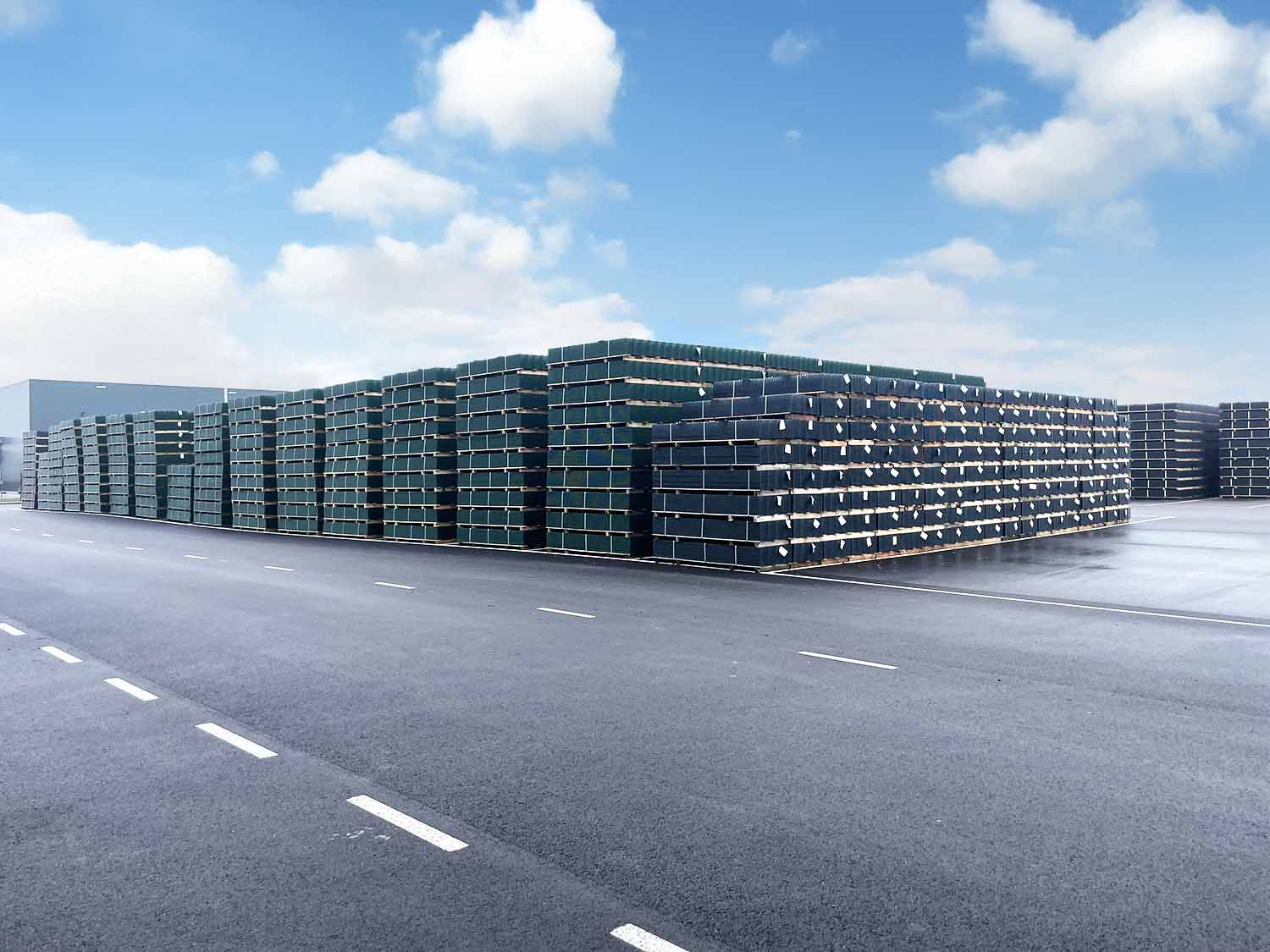 Large stacks of welded mesh panels on pallets in the yard at our own production site