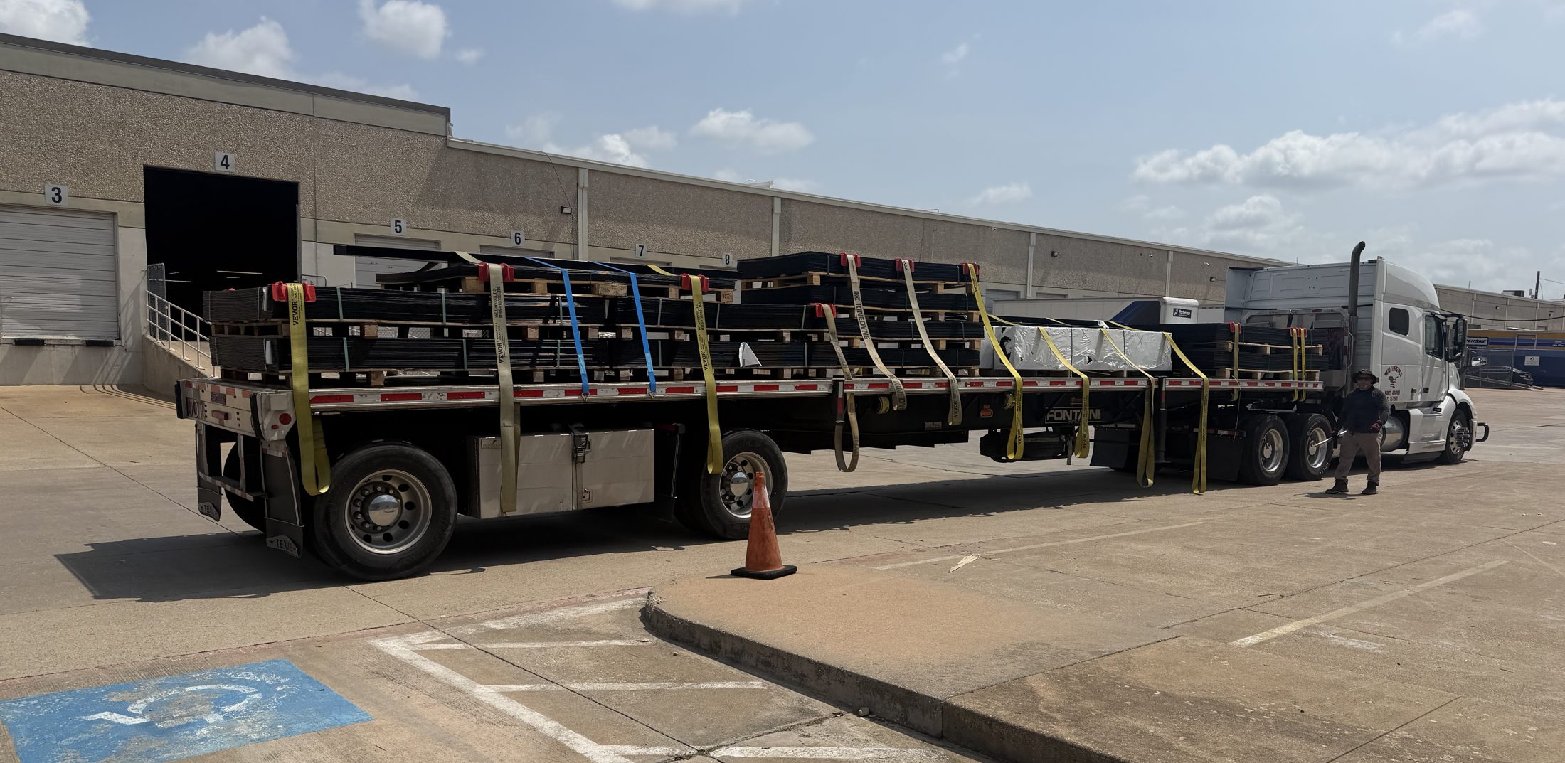 Flatbed truck loaded with fence panels at the Dallas warehouse dock