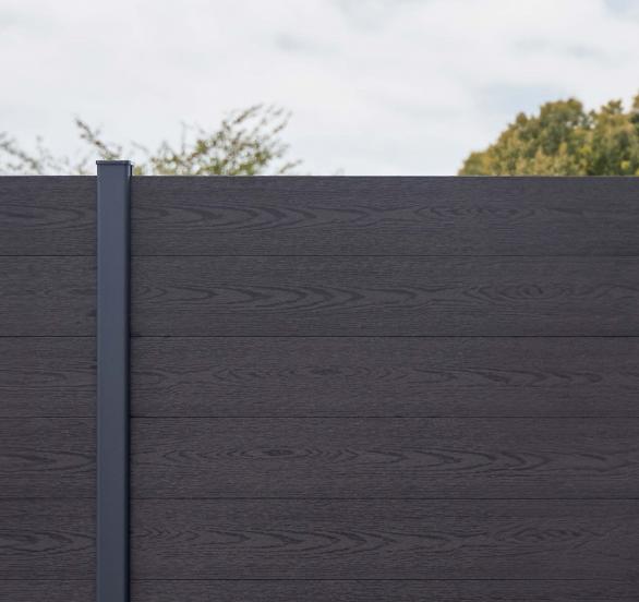Composite privacy fence boards in a garden