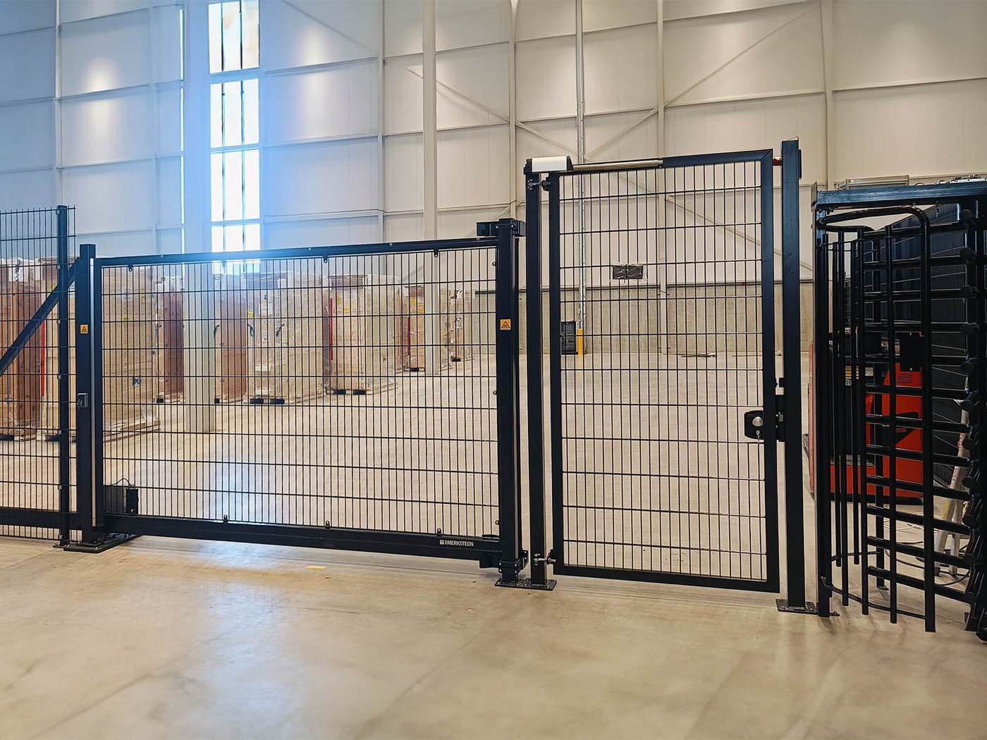 Installed security fence with an electric gate inside an industrial building
